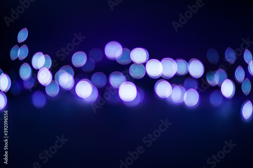 Abstract blurred purple lights bokeh background. Defocused lights.