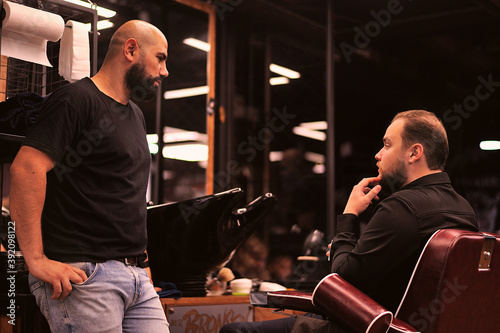 Brutal barber shaves a man in a barbershop