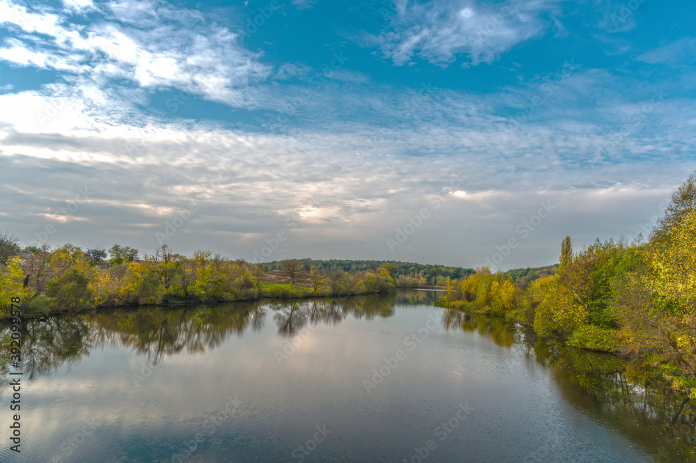 The Rostavitsya river in the Kyiv region with dense deciduous trees on both banks. Ukraine