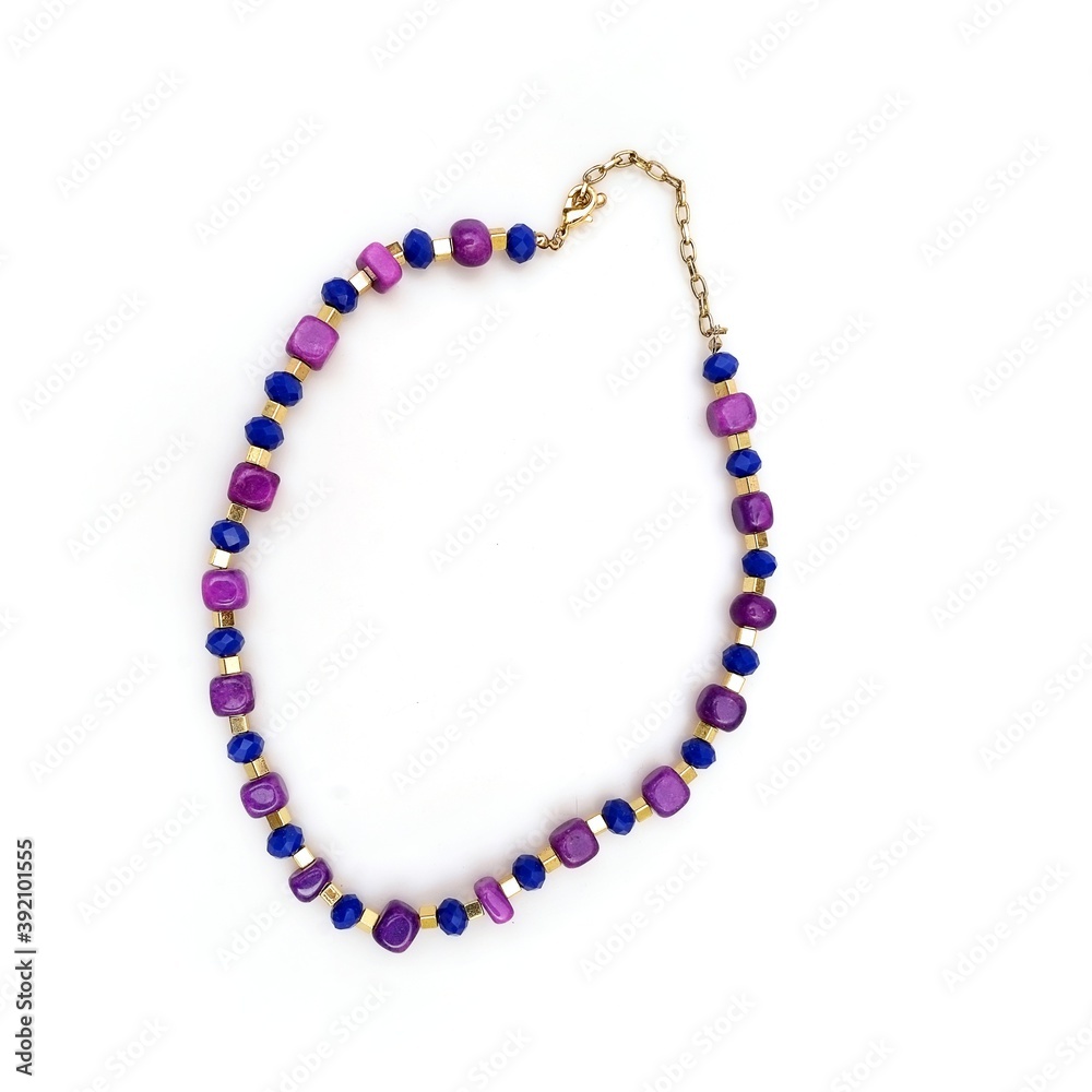 Obraz premium Golden necklace with gemstones isolated on a white background