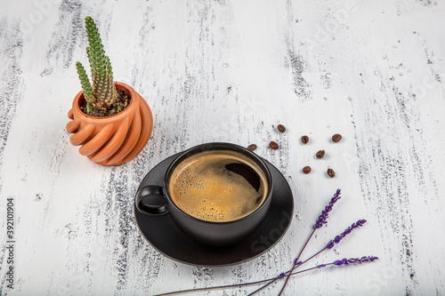 Double espresso. Close up espresso glass cup with coffee bean, on old wooden table photo