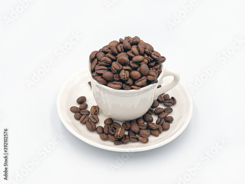 coffee beans in a white cup on the background