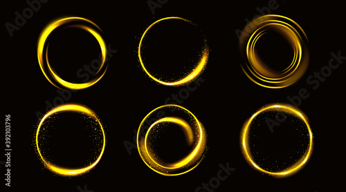 Gold circles with sparkles, golden round frames, shiny borders with glitter or fairy dust, glowing rings, fantasy design elements isolated on black background Realistic 3d vector illustration, set photo