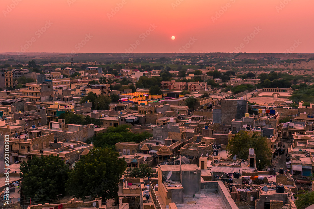 A view across the roof tops of Jaisalmer Rajasthan, India at sunset