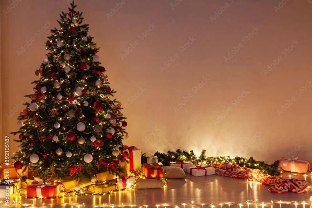 Lights garland Christmas tree with gifts interior new year night