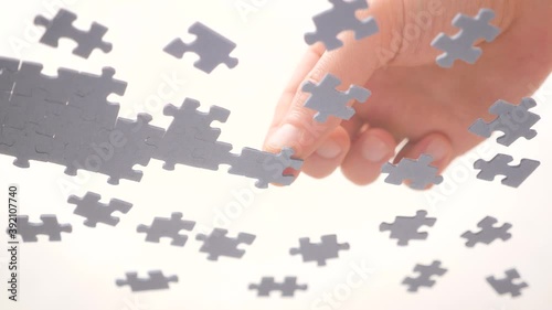 Bottom View. Human Hands Assembling Jigsaw Puzzle. Pastime, a hobby. Complex project management. Playing Calm Board Game. Unfinished Jigsaw Puzzle. Finding a Solution. Task and subtask concept