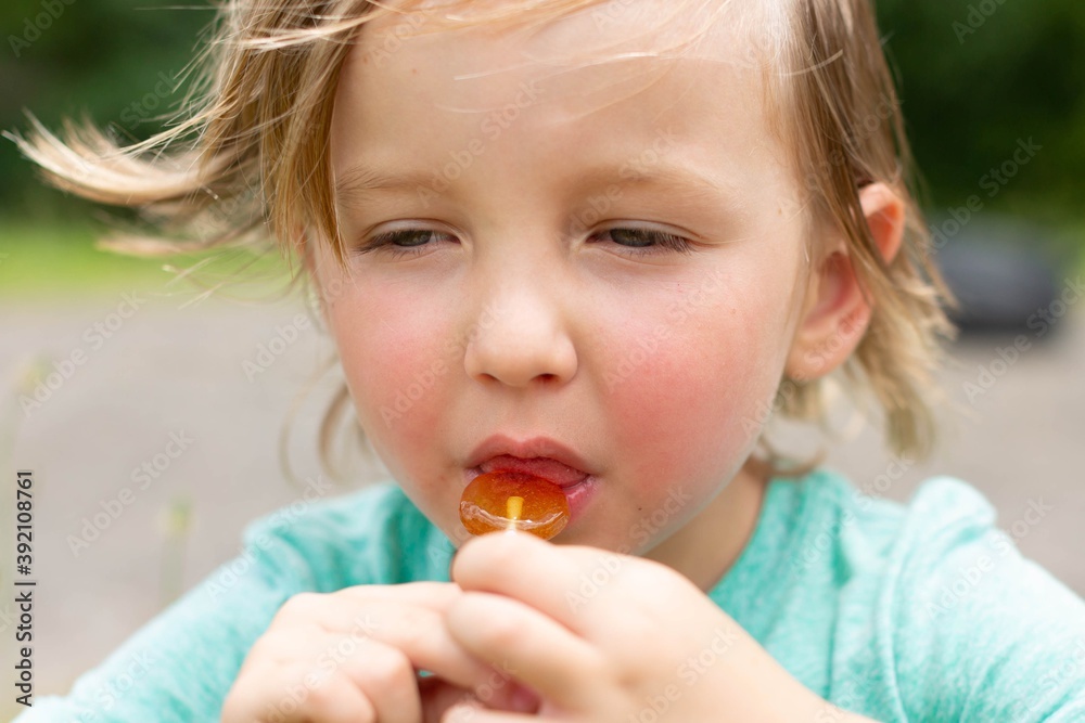 Little kid eating candy lollipop. Sweets and sugar. Little kid eating candy lollipop. Sweets and sugar.