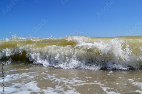 Foamy tide crushing on the beach