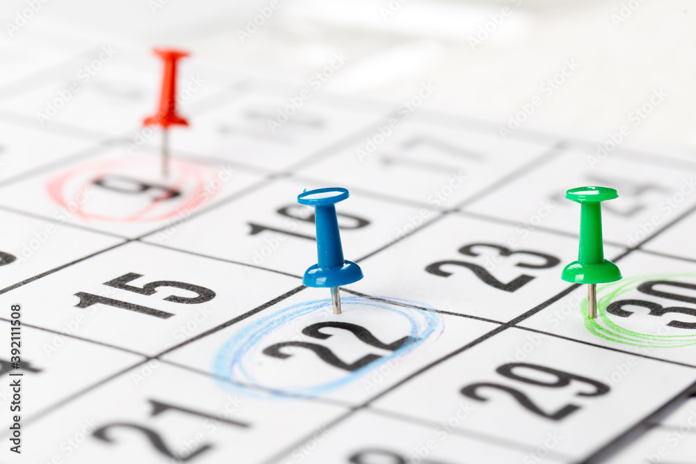 Thumbtack in calendar concept for busy, appointments and meeting reminders Thumbtack in calendar concept for busy, appointments and meeting reminders