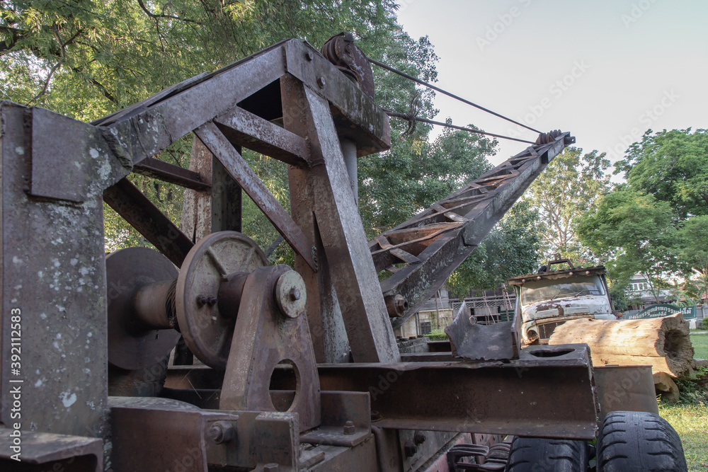 Fototapeta premium Loading heavy industrial old logging truck machine. Parts of an old logging truck abandoned, select focus.