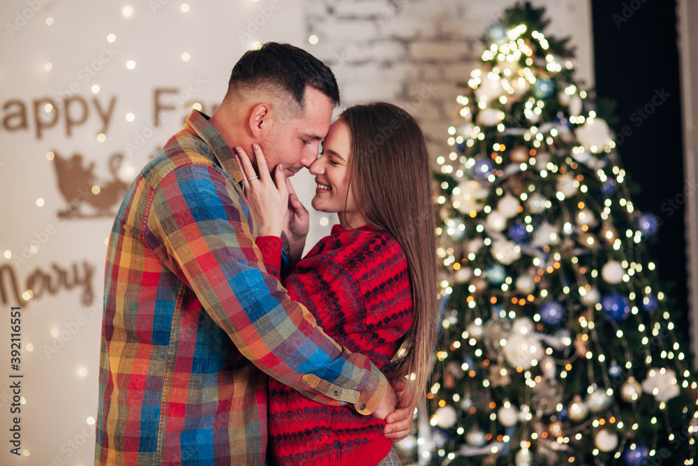 lovers hugging near the christmas tree lovers hugging near the christmas tree