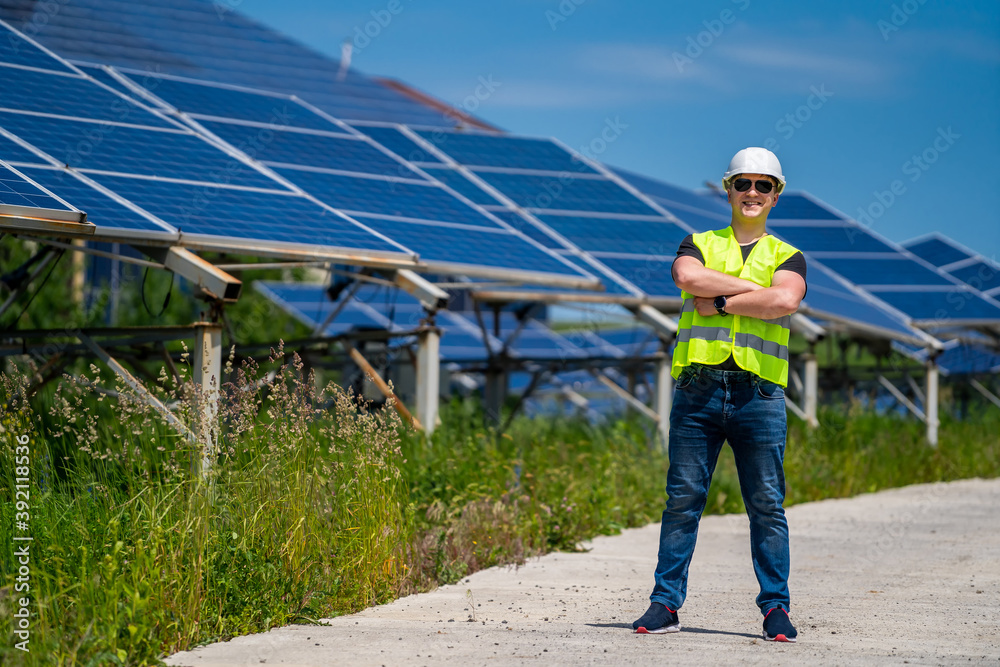 The portrait of a proud young engineer satisfied with his successful work. Renewable energy, technology, electricity, service, green power. The portrait of a proud young engineer satisfied with his successful work. Renewable energy, technology, electricity, service, green power.