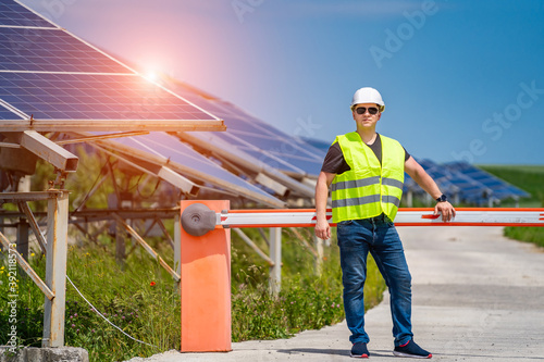 Engineer in worker helmet on solar panels background. Solar power panel. Green energy. Electricity. Power energy pannels.