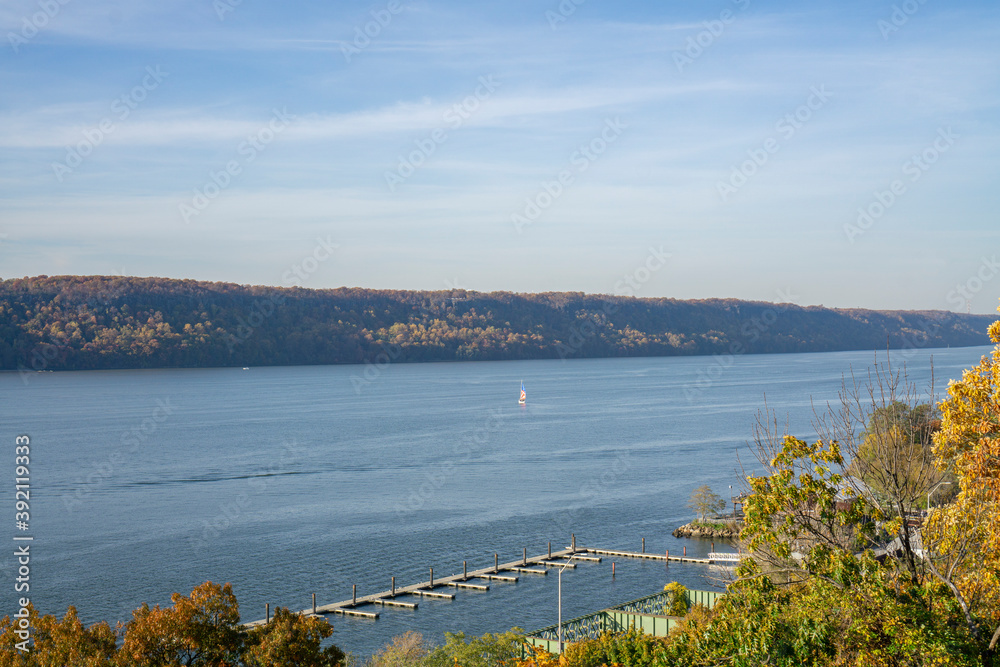A view on Hudson river with a few boats swimming around. Water surrounded by trees