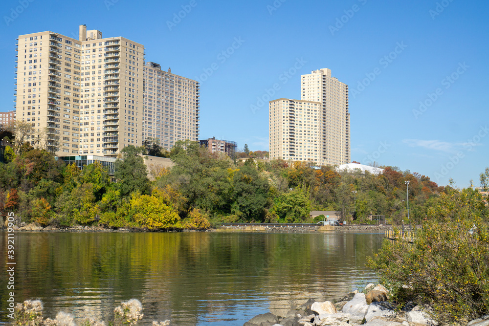 Apartment complex buildings with a view of creek and Inwood Hill Park