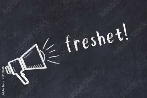 Chalk loudspeaker and inscription freshet on black chalkboard