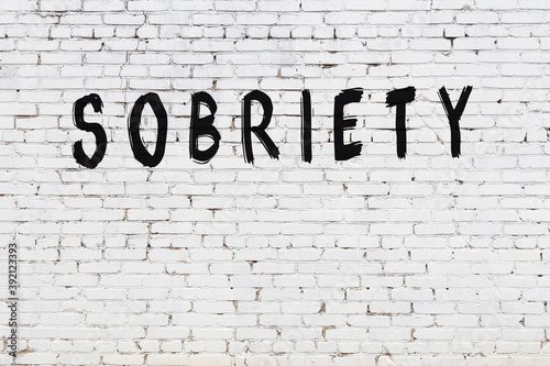 Photos White wall with black paint inscription sobriety on it