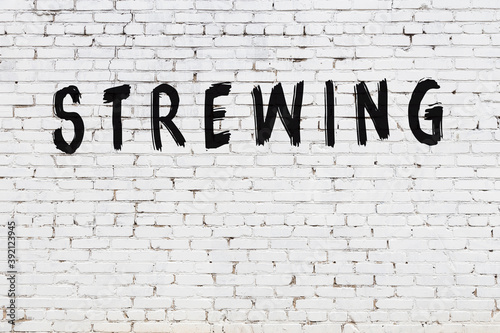 Fotografie Inscription strewing painted on white brick wall