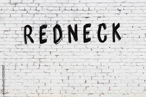 Inscription redneck painted on white brick wall photo