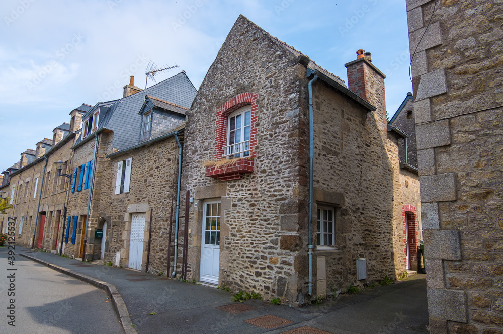 Dinan, France - August 26, 2019: Old street with stone medieval houses in the historic town centre of Dinan, French Brittany