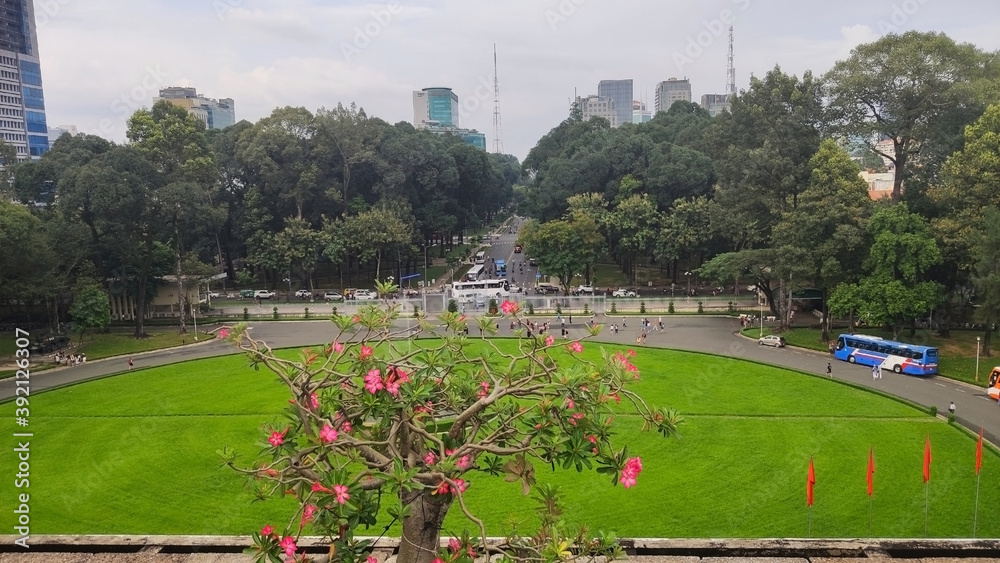 View from Reunification Palace. Tall houses, tourist bus and trees. Ho Chi Minh City (Saigon). Vietnam. South-East Asia