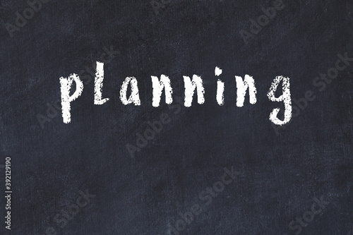 Foto College chalk desk with the word planning written on in