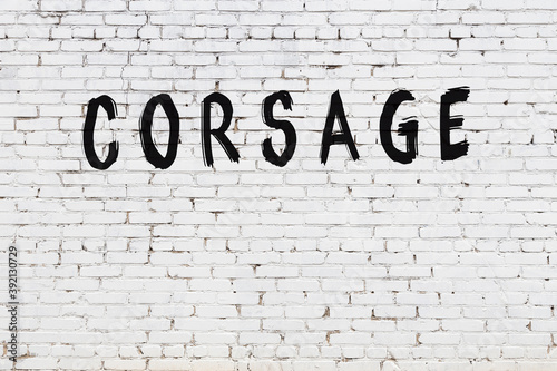 Bild auf Leinwand White wall with black paint inscription corsage on it