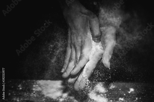 closeup of hand sprinkling flour on table with black background c  rdoba argentina
