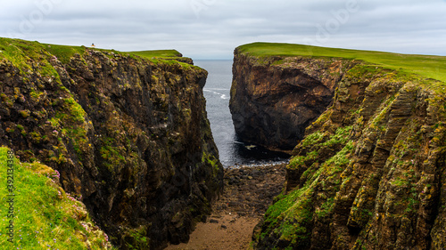 Eshaness Cliffs on the western coastline on Shetlands Mainland during a cloudy summer day photo