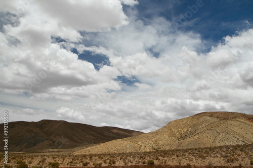 Altiplano. Desert landscape. Majestic view of the arid valley and mountains under a dramatic cloudy sky.