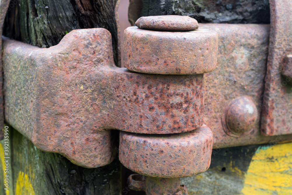 Heavy hinge on an old abandoned ore cart at disused iron mine. Heavy hinge on an old abandoned ore cart at disused iron mine.