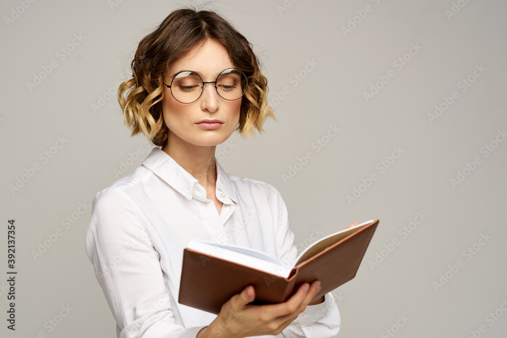 woman with notepad in hands business work beige background glasses hairstyle woman with notepad in hands business work beige background glasses hairstyle