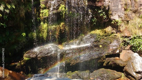 Rainbow over little waterfall