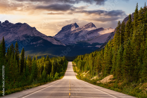 Scenic road in the Canadian Rockies. Dramatic Colorful Sunset Sky. Taken in Icefields Parkway, Banff National Park, Alberta, Canada.