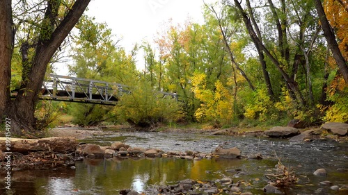 Biker passing a bridge over the Boulder Creek photo