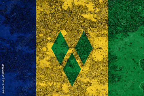 Flag of Saint Vincent and the Grenadines painted on the old grunge rustic iron surface. Abstract paint of Saint Vincent and the Grenadines national flag on the iron surface