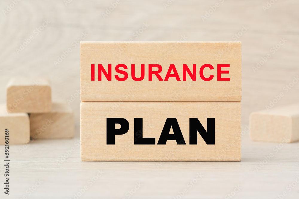 the word PLAN INSURANCE is written on a wooden cubes structure. Cube on a bright background. Can be used for business, marketing, financiaL, INSURANCE concept. Selective focus.