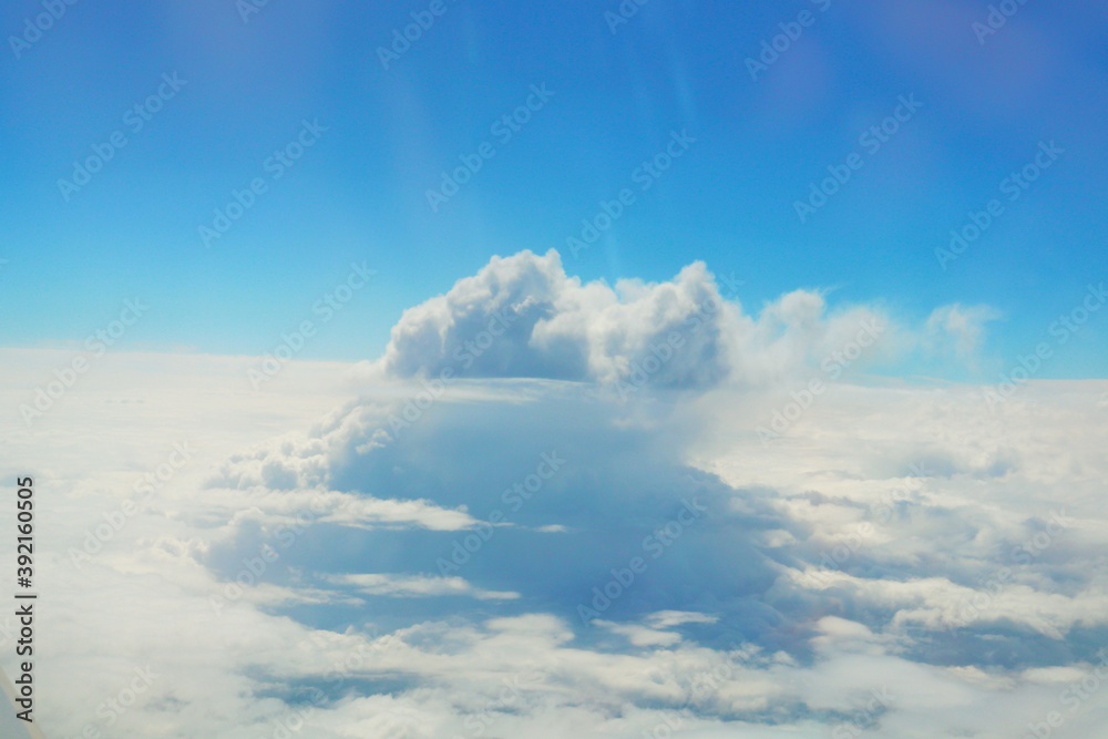 Fototapeta premium Clouds and blue sky view from airplane window