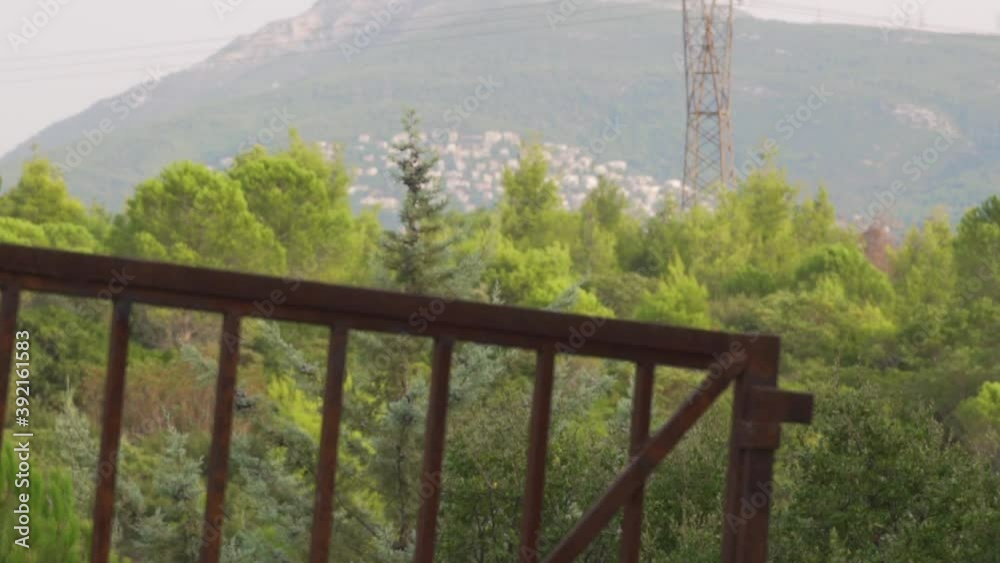 Tilt shot of Penteli mountain, Athens , greece, view from Parnitha mountain . Old rusty metal fence door in the foreground Tilt shot of Penteli mountain, Athens , greece, view from Parnitha mountain . Old rusty metal fence door in the foreground