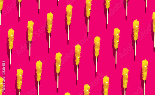 Shugar yellow candy pattern flat lay on Raspberry Sorbet background. Christmas, new year creative wallpaper dessert ornament