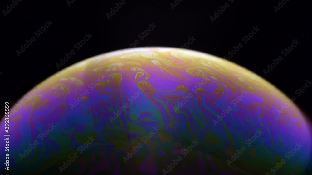 Beautiful rainbow bubble planet in black background -close up Beautiful rainbow bubble planet in black background -close up