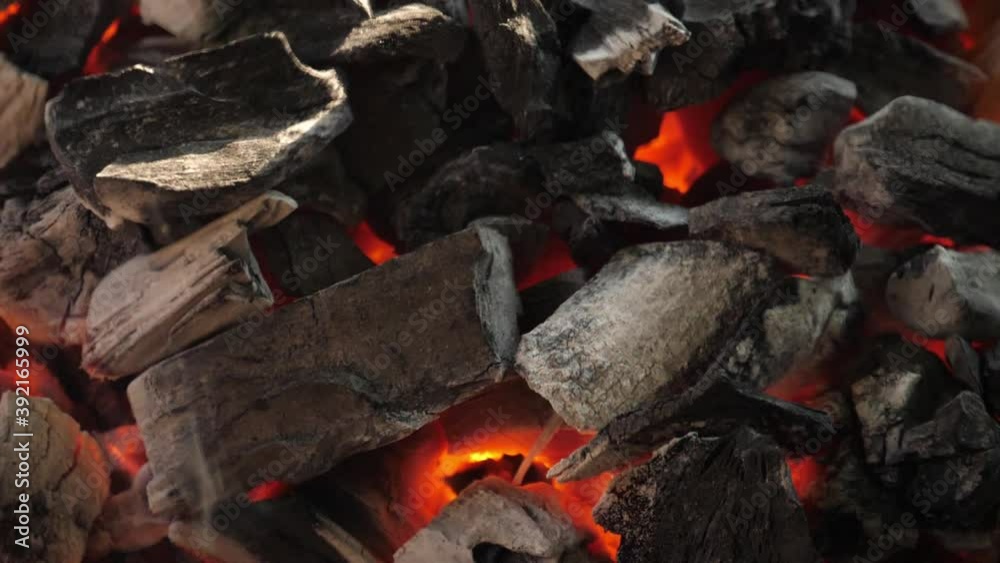 Slow motion speed close up scene of burning charcoal pile with white ash, mirage illusion movement from hot stream of air, outdoor cooking activity, crumble texture of live coal. Slow motion speed close up scene of burning charcoal pile with white ash, mirage illusion movement from hot stream of air, outdoor cooking activity, crumble texture of live coal.