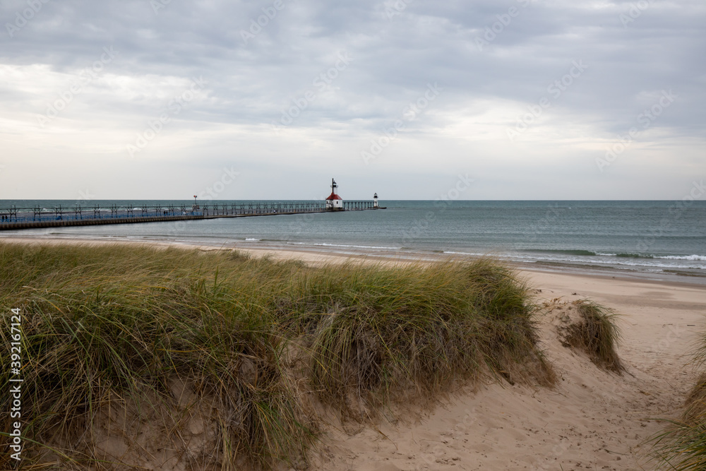 St. Joseph North Pier Lighthouse at Tiscornia Park and Lake Michigan beach in Fall.