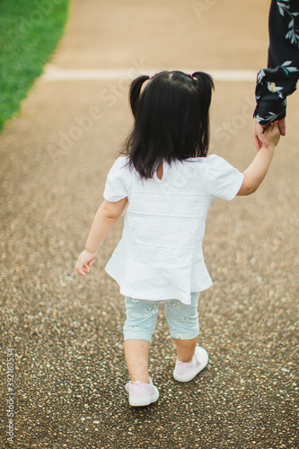 Toddler walking in the park on daylight