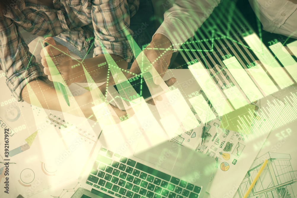 Double exposure of forex graph drawing and man and woman working together holding and using a mobile device. Trade concept.