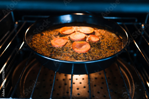 plant-based food,  vegan lentil loaf with carrots and onions cooking in the oven photo