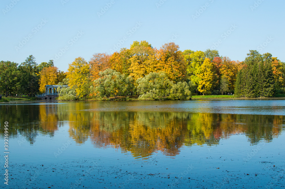 reflection of autumn forest in blue lake in the park reflection of autumn forest in blue lake in the park
