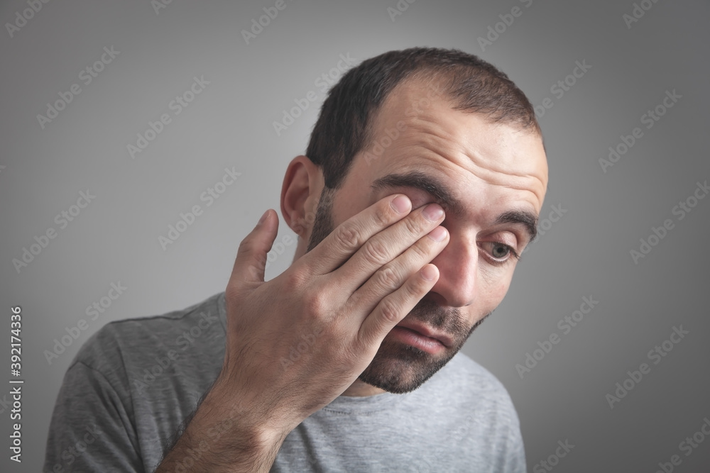 Caucasian man having vision problems. Caucasian man having vision problems.