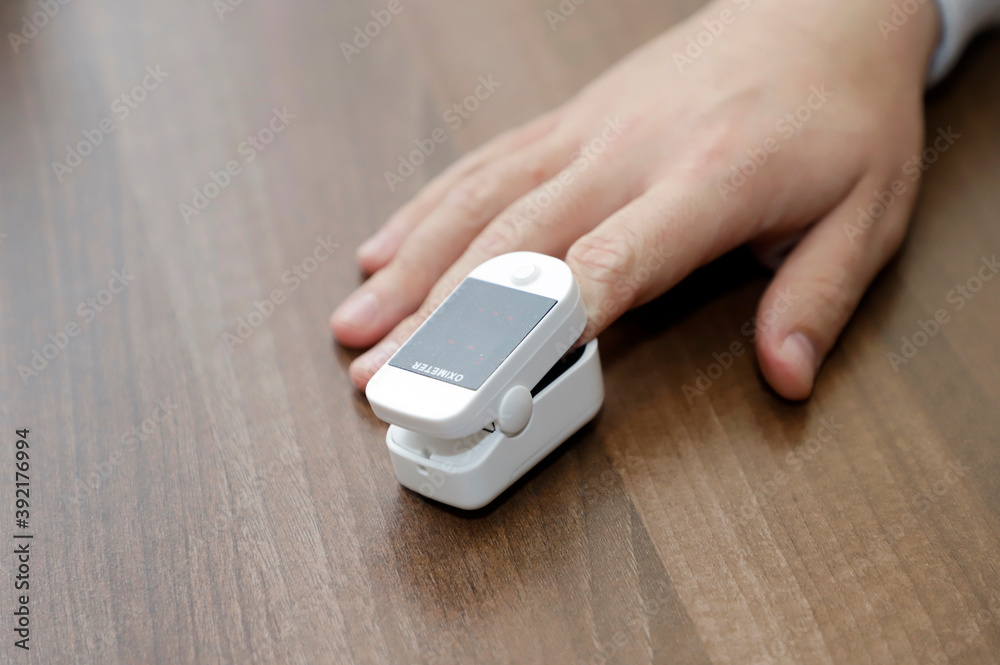 oximeter on a man's finger to measure blood oxygen in a coronavirus patient oximeter on a man's finger to measure blood oxygen in a coronavirus patient