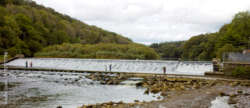 Lopwell Dam, a weir on the River Tavy, an access road crosses below the dam, Devon, England, UK. photo